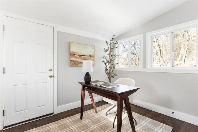 home office featuring lofted ceiling and dark hardwood / wood-style flooring