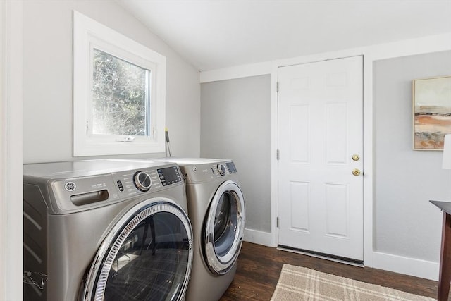 laundry area with dark hardwood / wood-style flooring and washer and clothes dryer