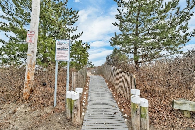 view of property's community featuring fence
