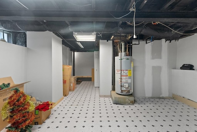 below grade area featuring water heater and tile patterned floors