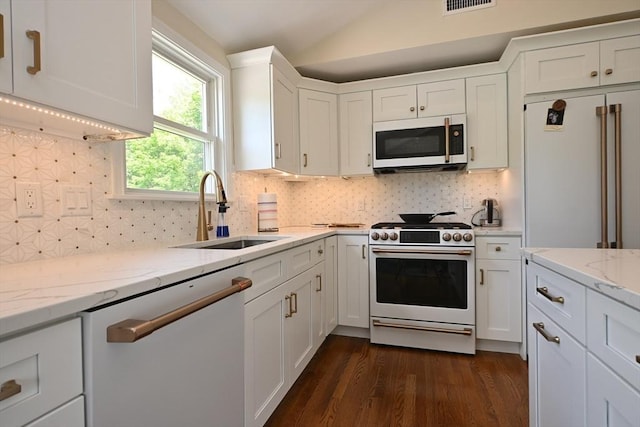 11 Edith Rd, Hudson, MA 01749 - kitchen with white appliances, a sink, white cabinets, dark wood-style flooring, and vaulted ceiling