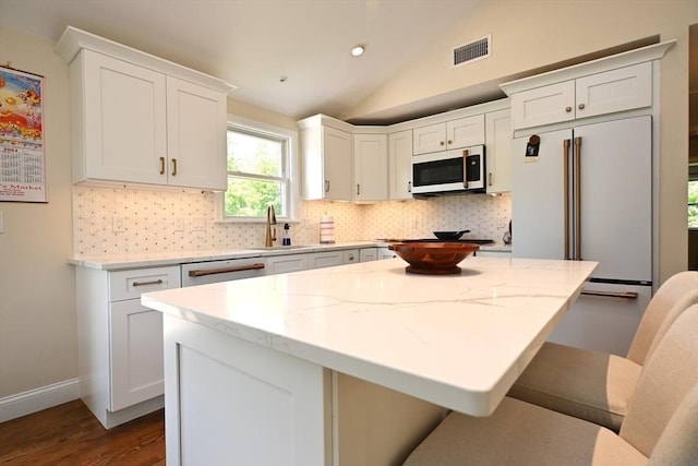 11 Edith Rd, Hudson, MA 01749 - kitchen featuring white appliances, a sink, tasteful backsplash, dark wood finished floors, and vaulted ceiling