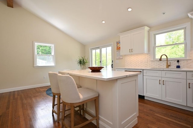 11 Edith Rd, Hudson, MA 01749 - kitchen with a sink, a kitchen island, dark wood-style flooring, vaulted ceiling, and white cabinetry