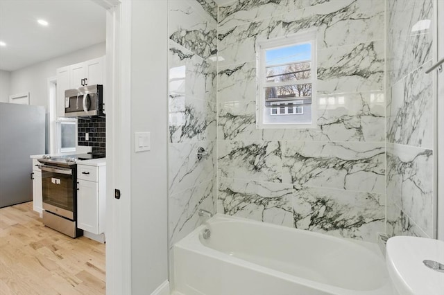 full bath with vanity, recessed lighting, shower / bathing tub combination, and wood finished floors