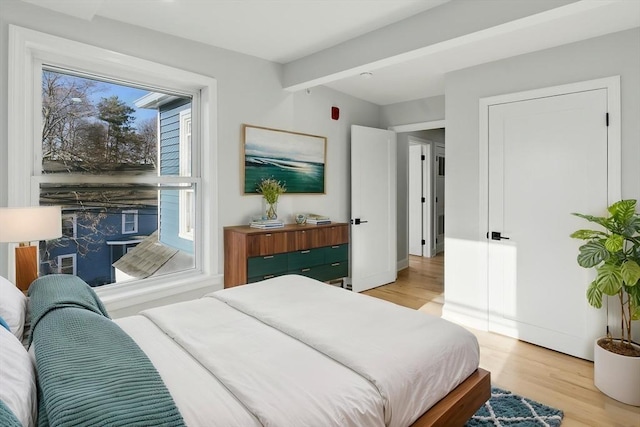 bedroom featuring baseboards and light wood-type flooring