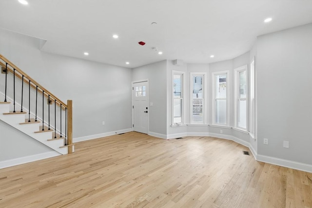 entrance foyer with light wood-style floors, baseboards, stairway, and recessed lighting