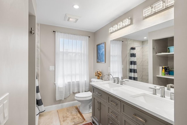 26 Weybosset St, Weymouth, MA 02191 - full bath with toilet, double vanity, curtained shower, and baseboards