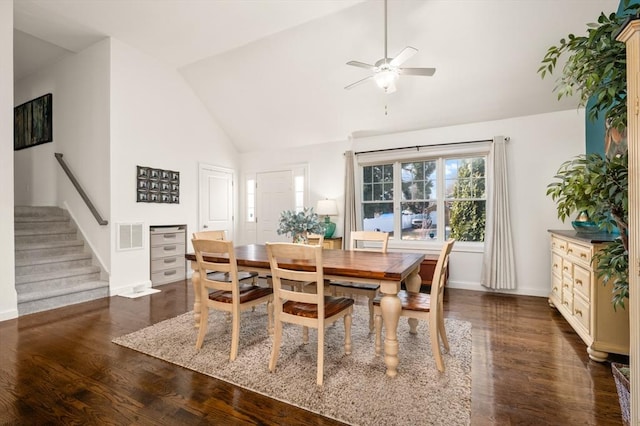 dining area featuring visible vents, stairway, ceiling fan, vaulted ceiling, and wood finished floors