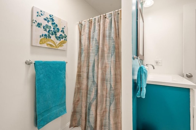 full bathroom with a shower with curtain and a sink