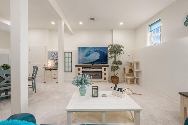 carpeted living area with recessed lighting, visible vents, and baseboards