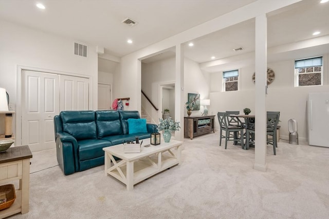 living room featuring visible vents, light colored carpet, and recessed lighting