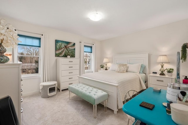 carpeted bedroom featuring multiple windows