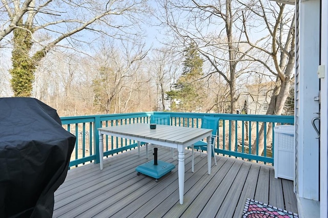 wooden deck featuring a grill