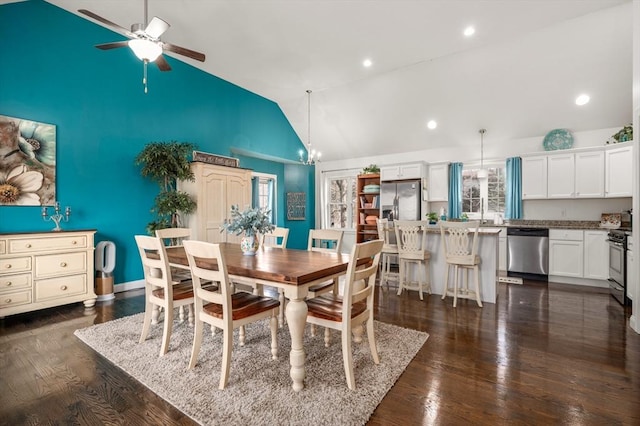 dining space featuring lofted ceiling, ceiling fan with notable chandelier, dark wood-style floors, and recessed lighting