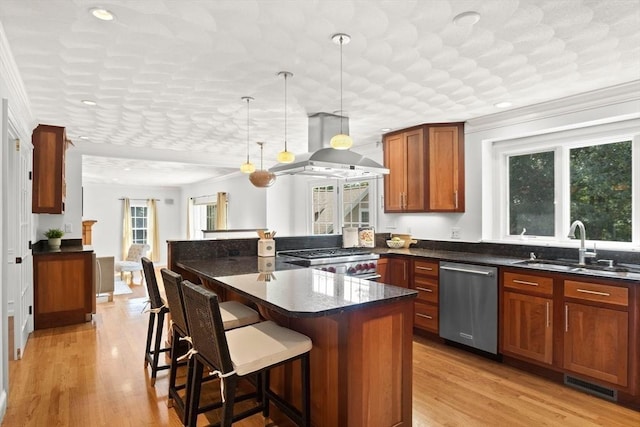 kitchen featuring pendant lighting, dishwasher, stove, a kitchen breakfast bar, and island range hood