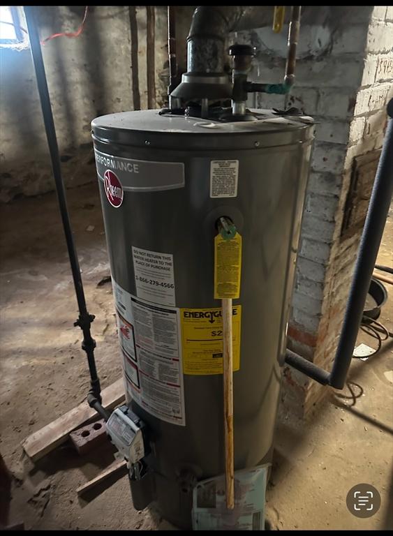 utility room featuring water heater