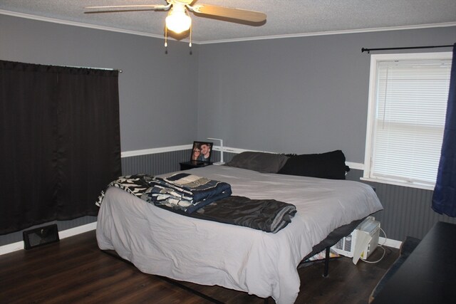 bedroom featuring ceiling fan, dark hardwood / wood-style flooring, ornamental molding, and a textured ceiling