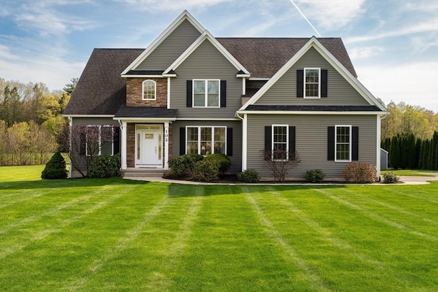traditional home with a front lawn and a shingled roof