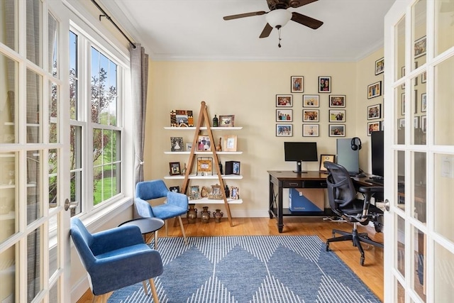 office area with french doors, crown molding, wood finished floors, a ceiling fan, and baseboards