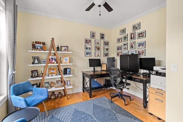 home office featuring wood finished floors, ceiling fan, crown molding, and baseboards