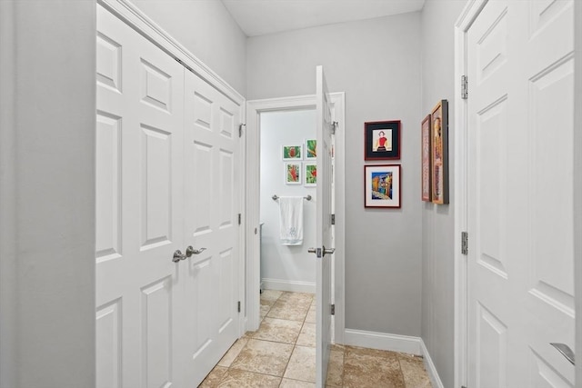 hall featuring baseboards