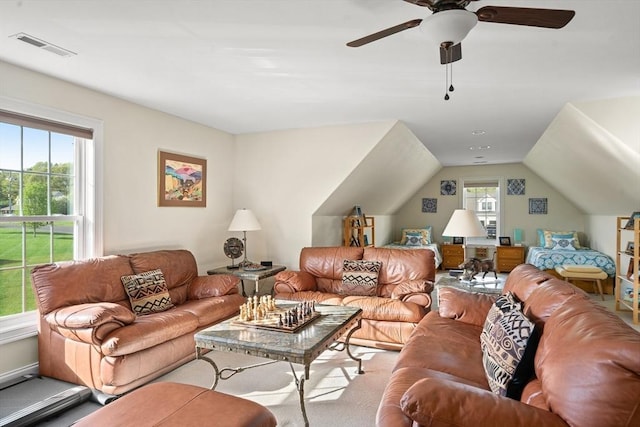 living room with a ceiling fan and vaulted ceiling