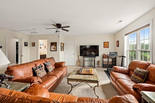 living room with carpet floors and a ceiling fan