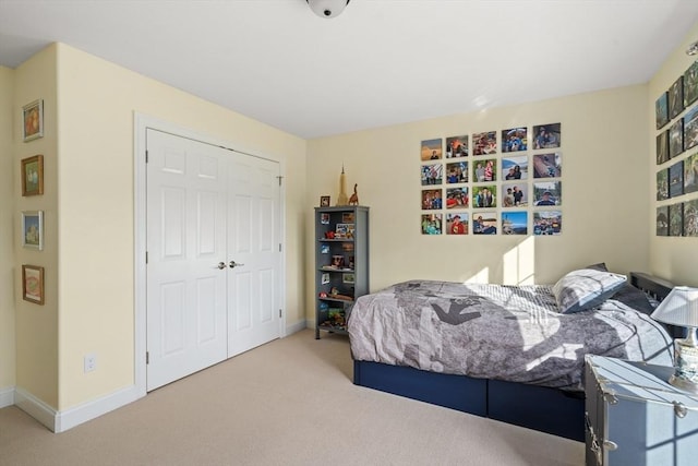 bedroom with carpet floors, a closet, and baseboards