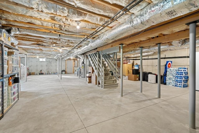 unfinished basement featuring stairs and gas water heater