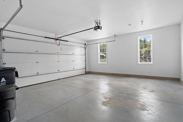 garage featuring a garage door opener and baseboards