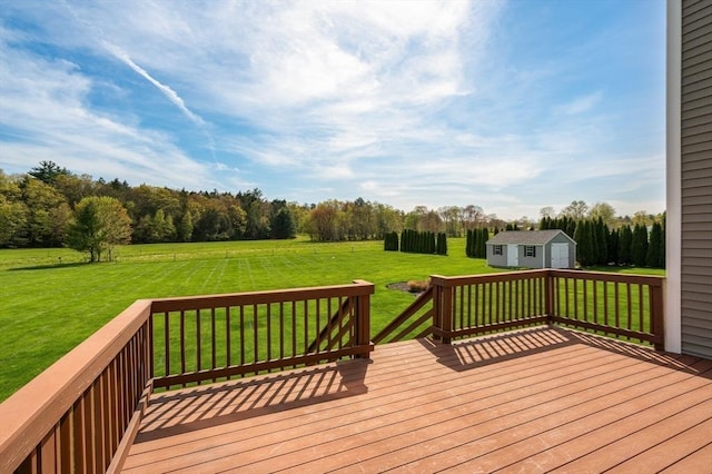 wooden terrace with an outbuilding, a shed, a yard, and a view of rural / pastoral area