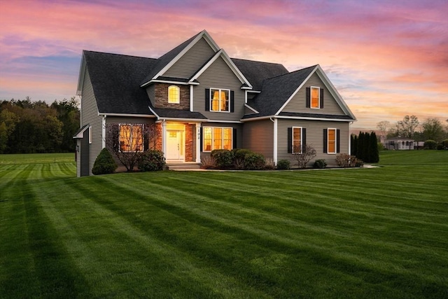 view of front of house with a lawn and stone siding