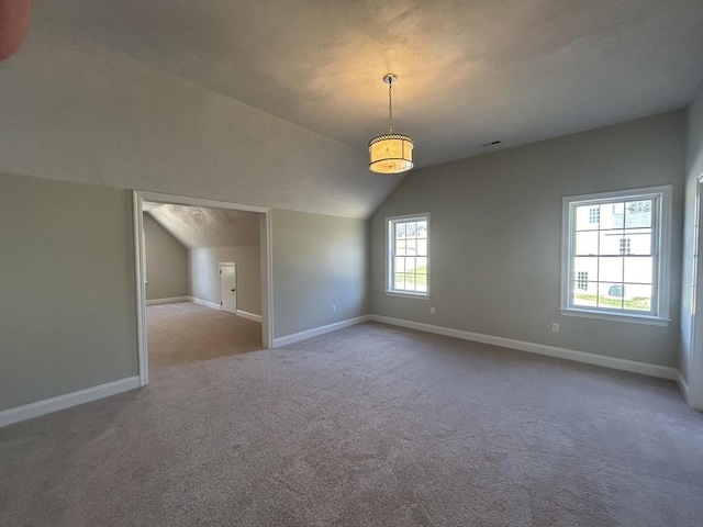 interior space with carpet floors and lofted ceiling