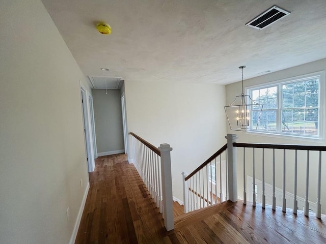 hall featuring a notable chandelier and dark hardwood / wood-style floors