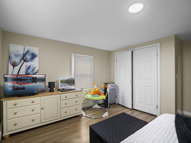 bedroom featuring dark wood-style flooring and a closet