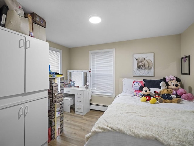 bedroom featuring a baseboard radiator and light wood finished floors