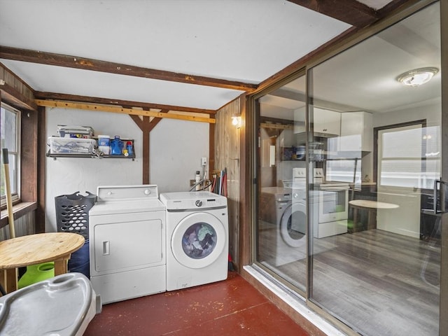 laundry room with washer and clothes dryer and plenty of natural light