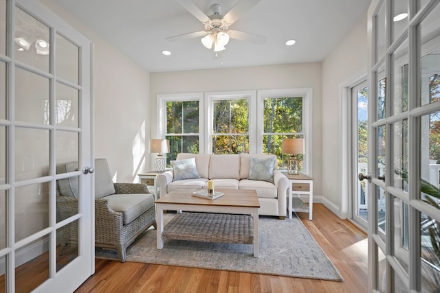 sunroom / solarium with ceiling fan, french doors, and a healthy amount of sunlight