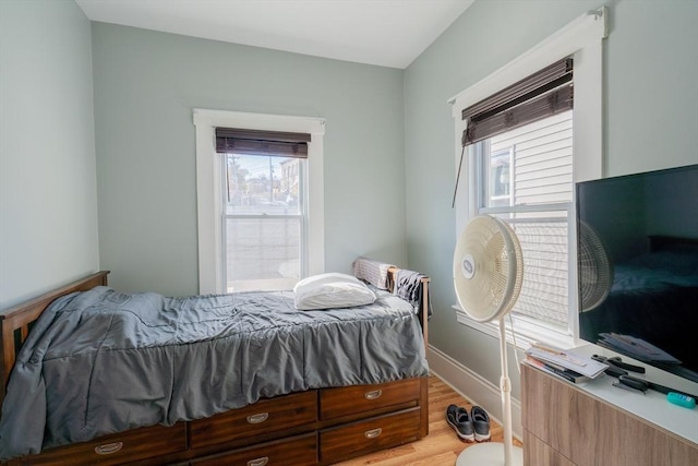 102 Gilman St, Somerville, MA 02145 - bedroom with multiple windows, light wood finished floors, and baseboards