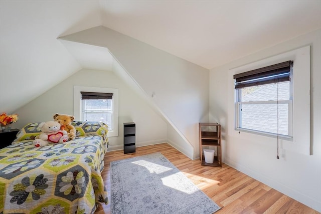 102 Gilman St, Somerville, MA 02145 - bedroom featuring multiple windows, wood finished floors, vaulted ceiling, and baseboards