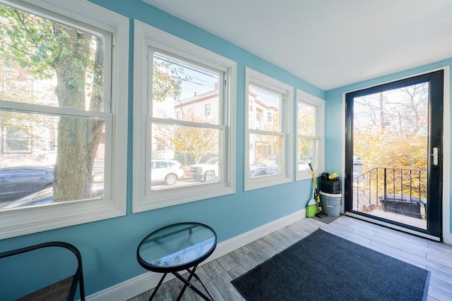 102 Gilman St, Somerville, MA 02145 - unfurnished sunroom with baseboards and wood finished floors