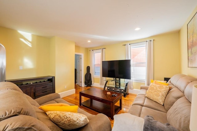 102 Gilman St, Somerville, MA 02145 - living room with light wood finished floors, baseboards, arched walkways, and recessed lighting