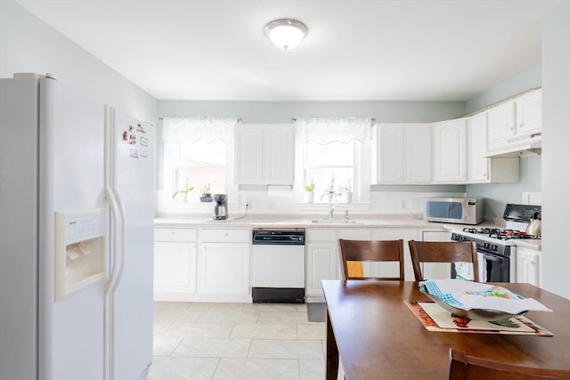102 Gilman St, Somerville, MA 02145 - kitchen featuring white appliances, under cabinet range hood, white cabinets, and a sink