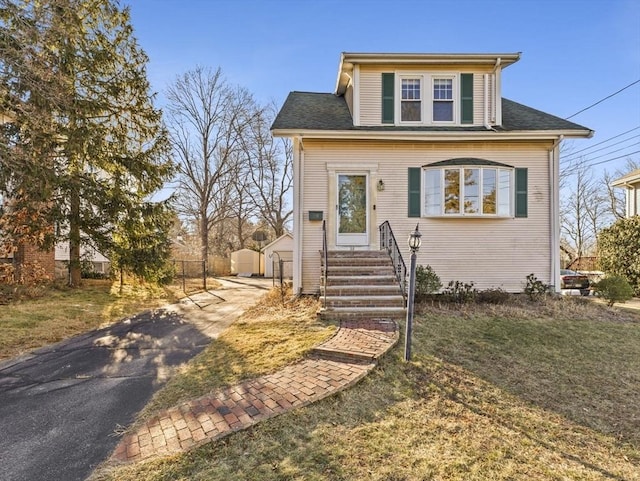 view of front of property with a front lawn and an outdoor structure