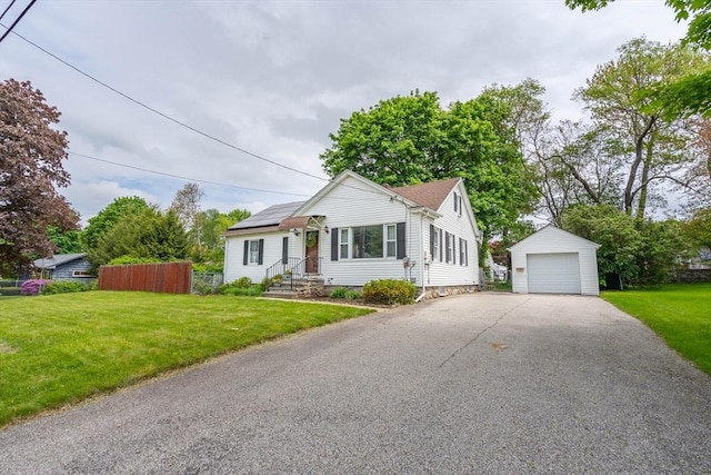 7 Prospect Ave, Dudley, MA 01571 - view of front of house featuring an outdoor structure, a detached garage, and roof mounted solar panels