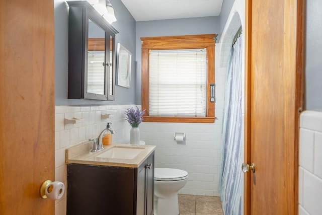 7 Prospect Ave, Dudley, MA 01571 - bathroom featuring tile walls, toilet, tile patterned floors, vanity, and a wainscoted wall