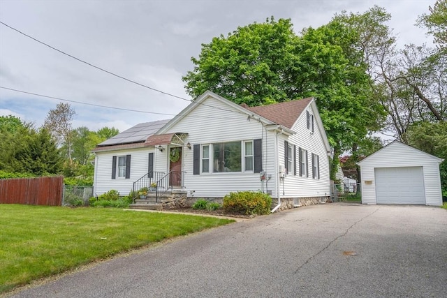 7 Prospect Ave, Dudley, MA 01571 - view of front of house featuring an outbuilding, a garage, asphalt driveway, and solar panels