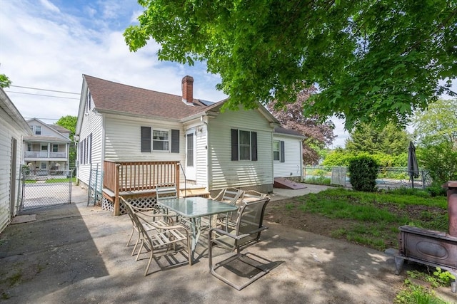 7 Prospect Ave, Dudley, MA 01571 - rear view of house featuring a chimney, fence, a patio, and outdoor dining space