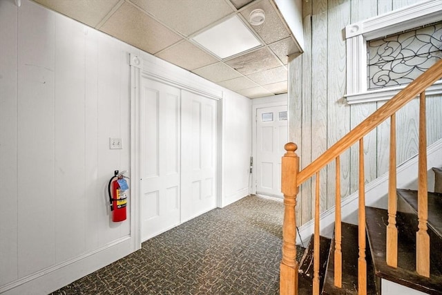 343 Cabot St, Beverly, MA 01915 - carpeted foyer entrance with a drop ceiling, stairway, and a decorative wall