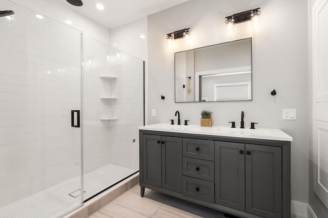 full bath featuring a shower stall, double vanity, and recessed lighting